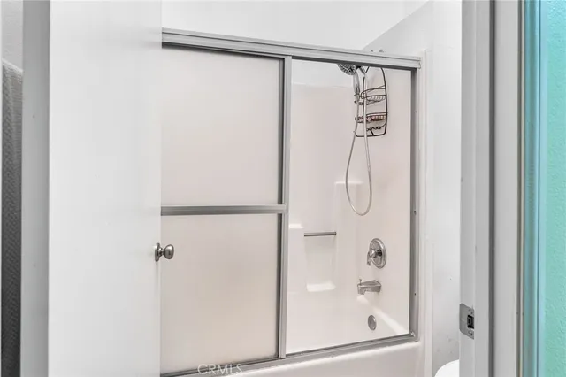 a view of walk in closet with clothes and closet