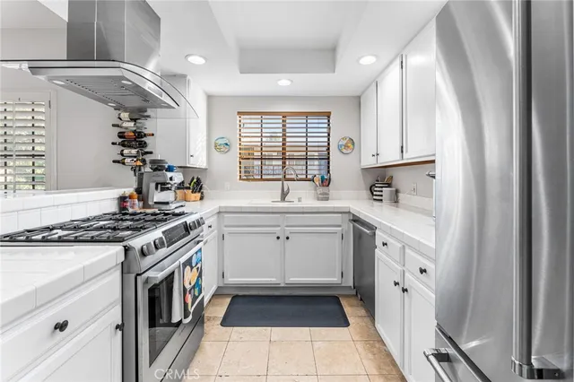 a kitchen with granite countertop a sink stove and cabinets