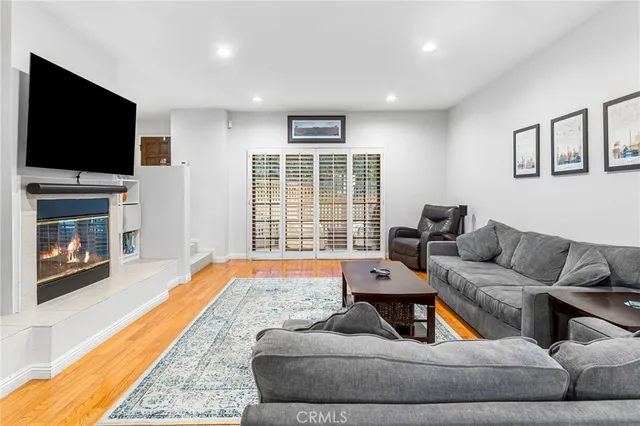 a living room with furniture tv and a fireplace