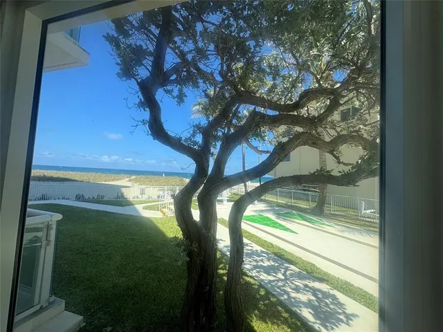 a bedroom with a bed dresser and a large window