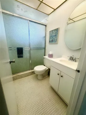 a bedroom with a bed and a mirror