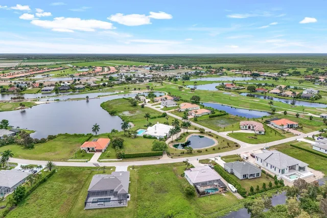 a view of a lush green outdoor space with a lake view