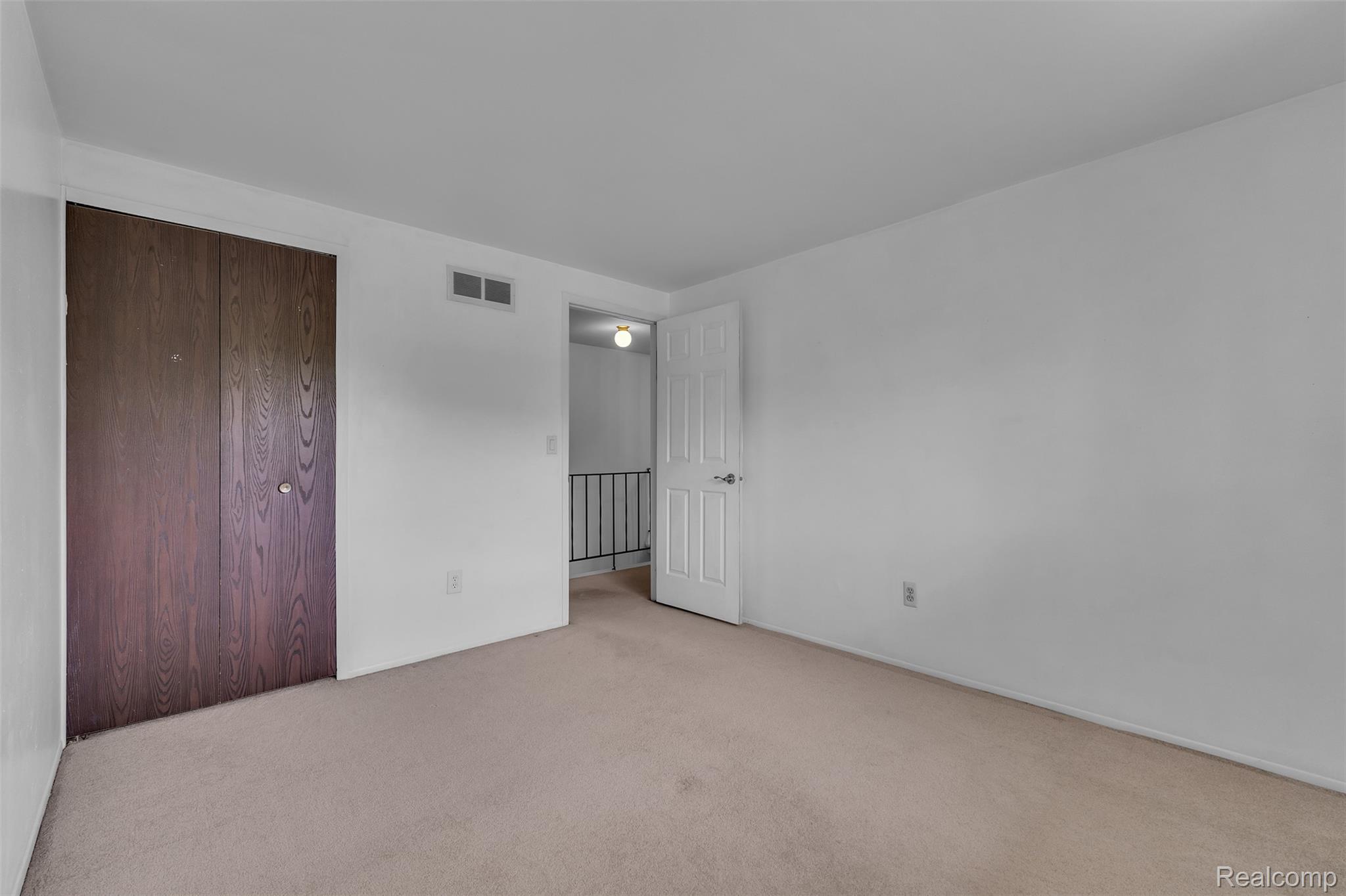7000 Woonsocket Street Canton, MI 48187 - Photo 40 of 65 Carpeted room featuring a white ceiling, light-colored walls, and a dark wood-finish closet door
