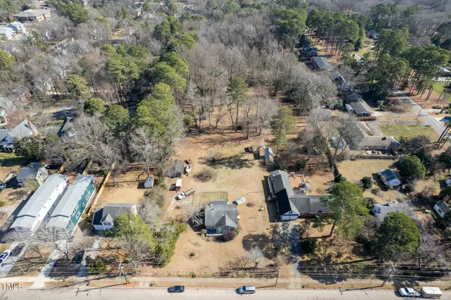 a view of a house with a yard covered in snow