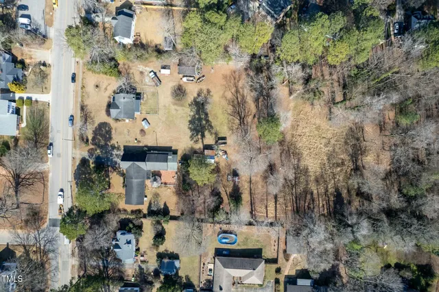 a view of a house with a yard covered in snow