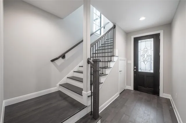 a view of entryway with wooden floor and stairs