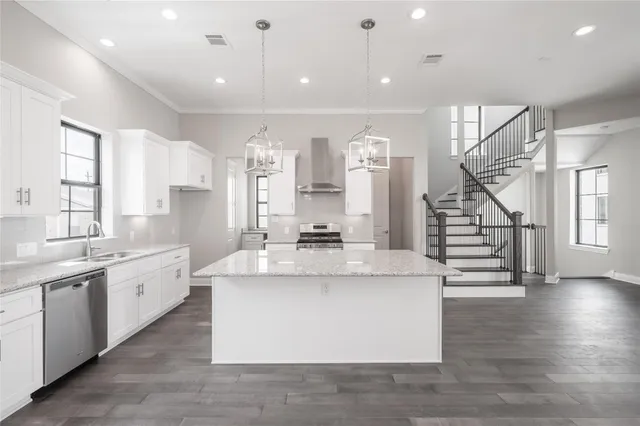 a view of kitchen with sink and refrigerator