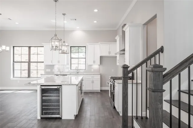 a kitchen with refrigerator cabinets and wooden floor