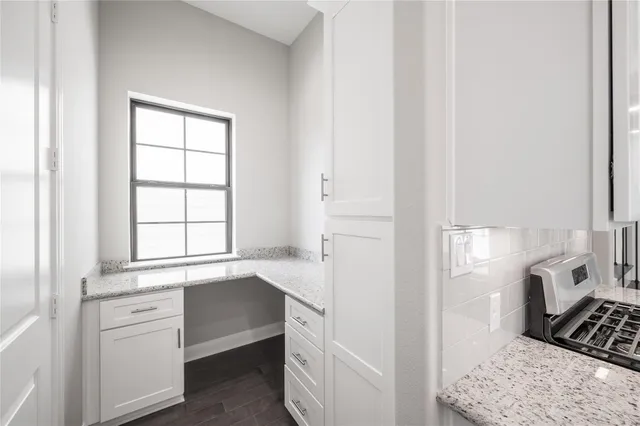 a spacious bathroom with a granite countertop sink and a mirror