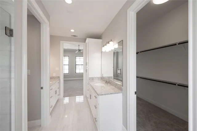 a spacious bathroom with a granite countertop tub sink and mirror