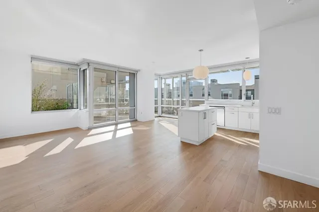 a view of a kitchen with wooden floor and windows