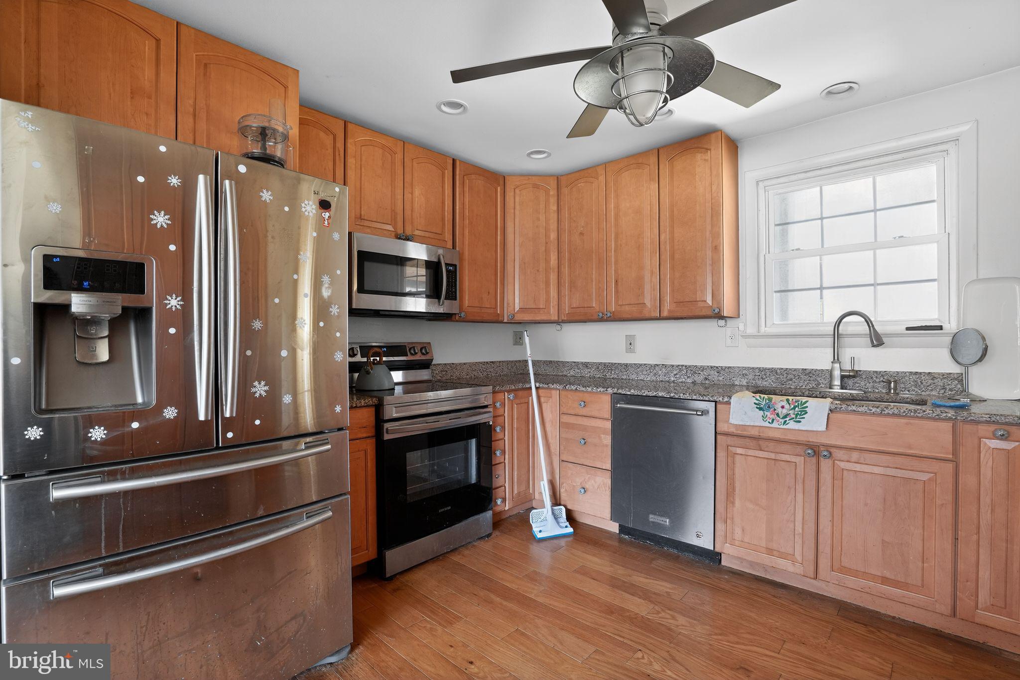 4144 Fox Trail Road Havre de Grace, MD 21078 - Photo 14 of 44 a kitchen with stainless steel appliances a stove sink and microwave