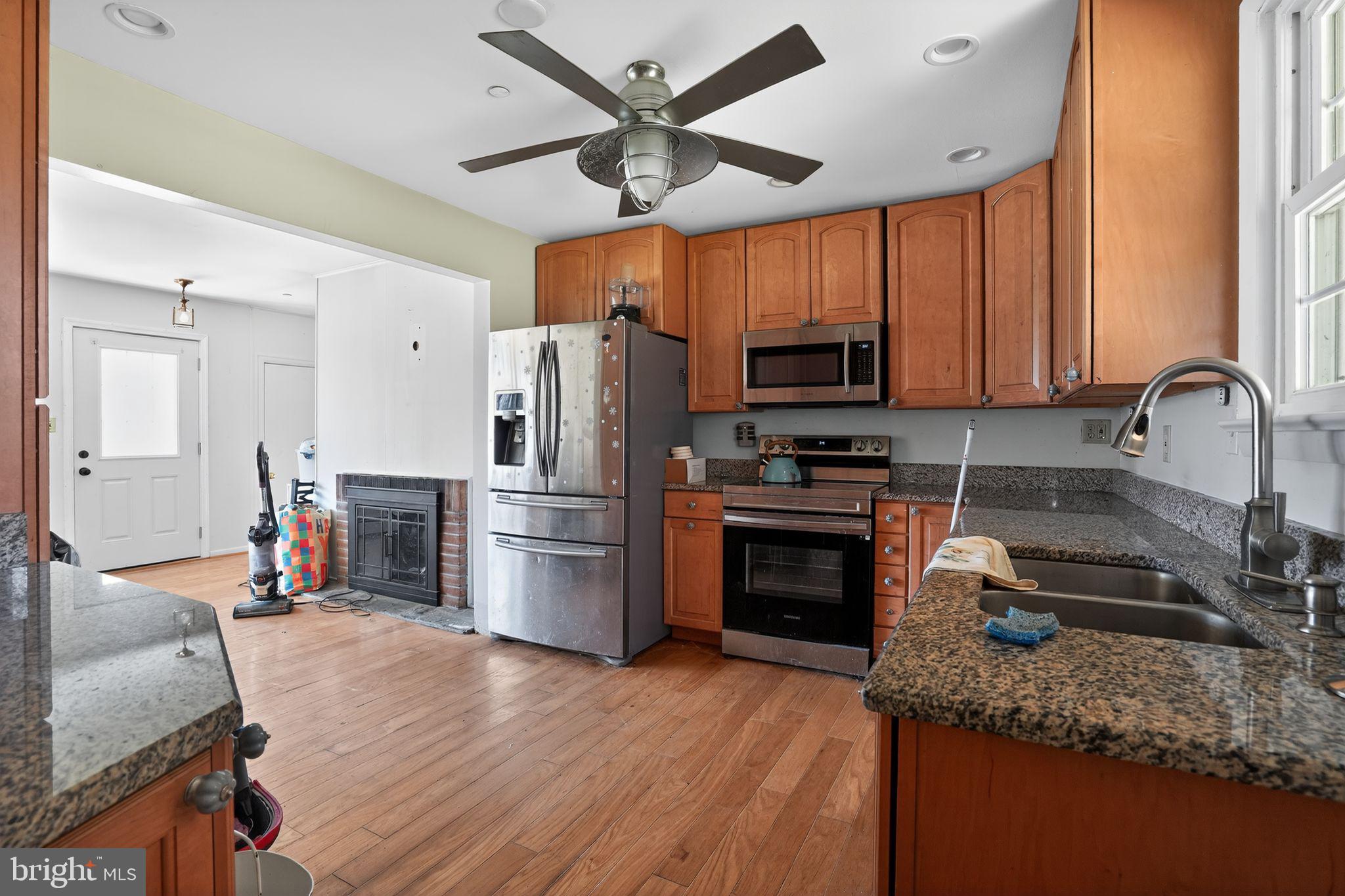 4144 Fox Trail Road Havre de Grace, MD 21078 - Photo 16 of 44 a kitchen with refrigerator a stove a sink cabinets and a dining table