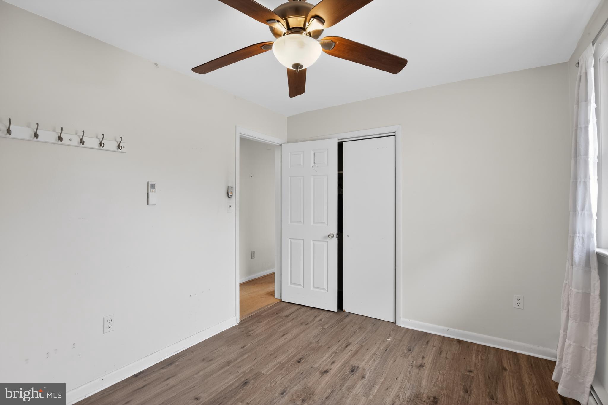 4144 Fox Trail Road Havre de Grace, MD 21078 - Photo 28 of 39 an empty room with wooden floor chandelier fan and closet in a room