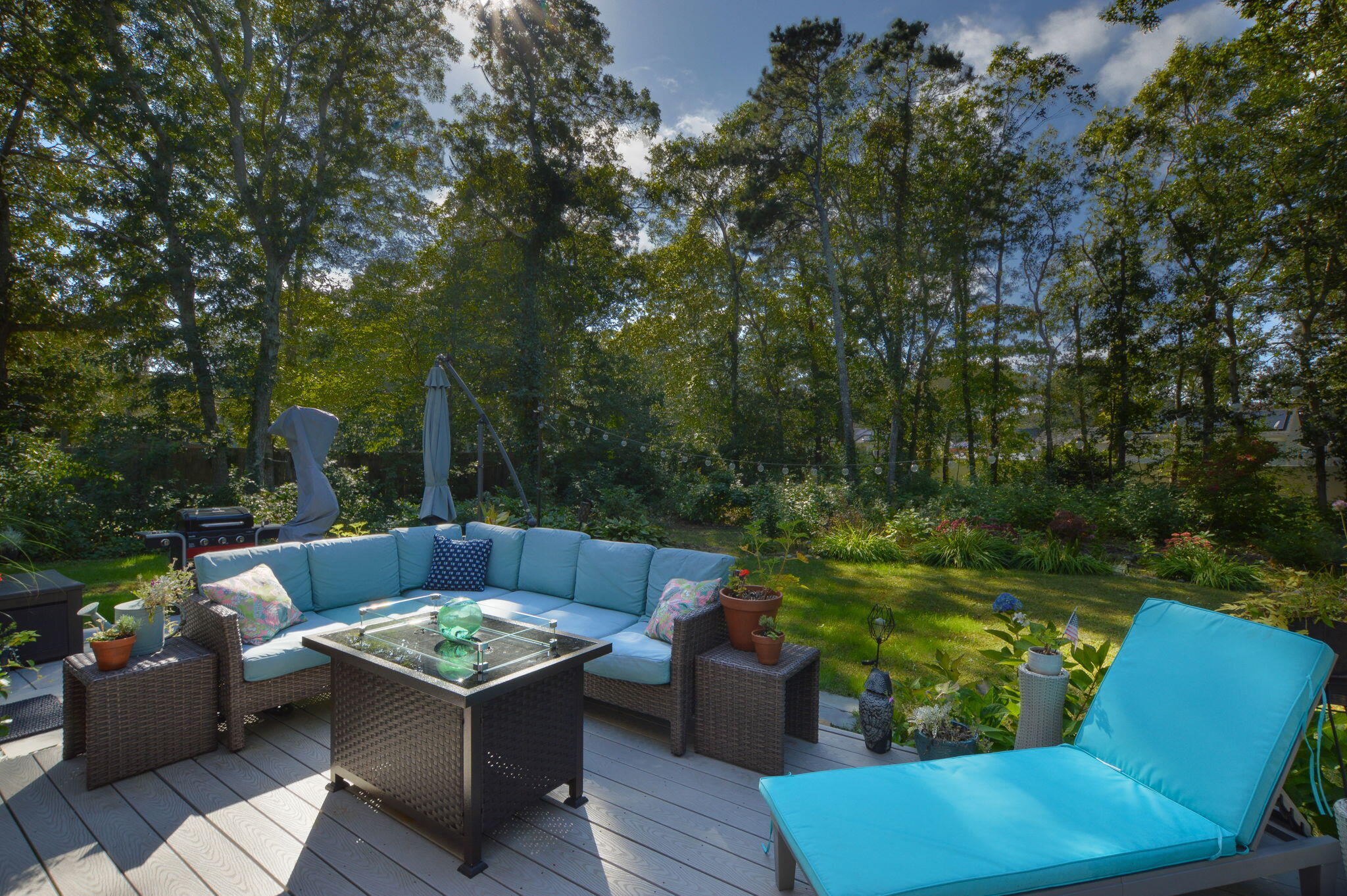 a view of a chair and fire pit in the backyard