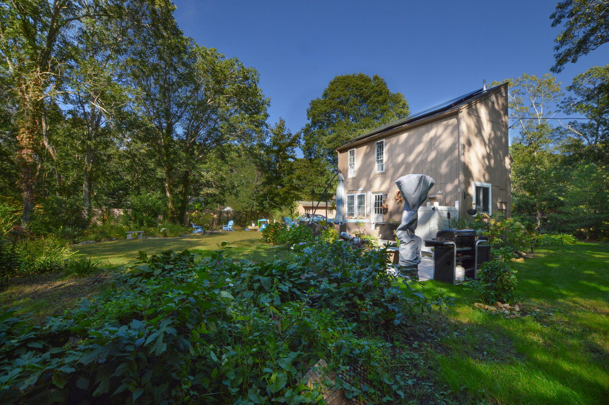 829 Pitcher's Way Hyannis, MA 02601 - Photo 25 of 32 a backyard of a house with lots of green space