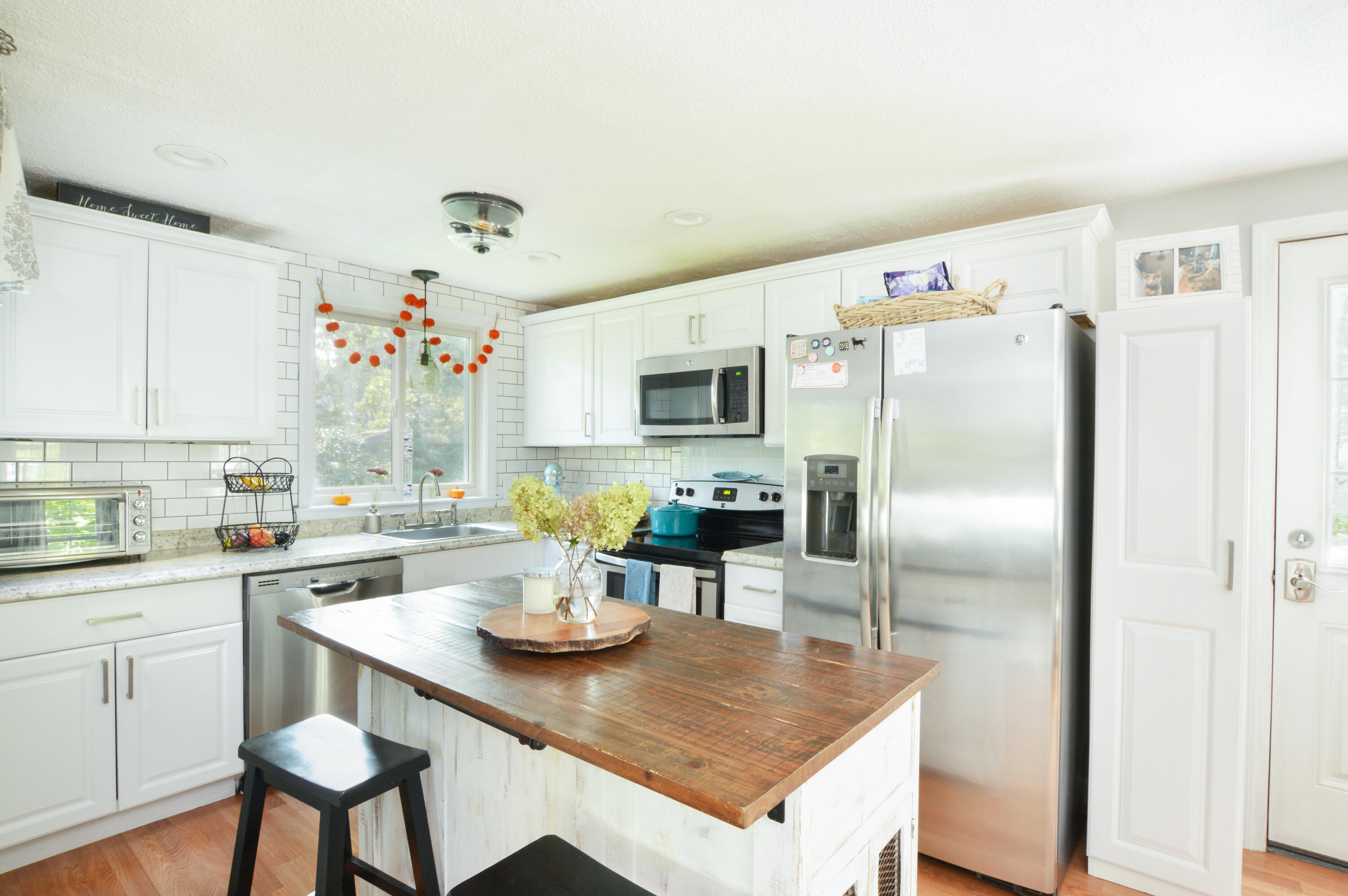 829 Pitcher's Way Hyannis, MA 02601 - Photo 6 of 32 a kitchen with a refrigerator a table and chairs in it