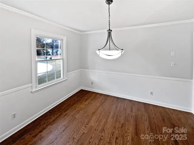 a view of a room with wooden floor and window