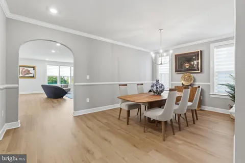 a bedroom with a bed and large windows