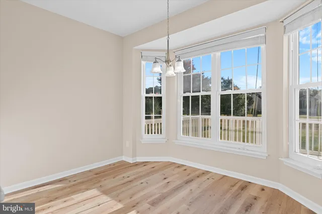 a view of wooden floor and a chandelier in a room