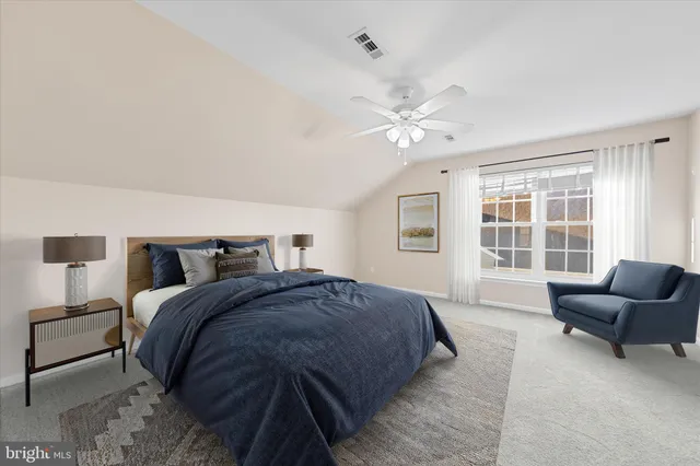 a spacious bedroom with a bed and a couch