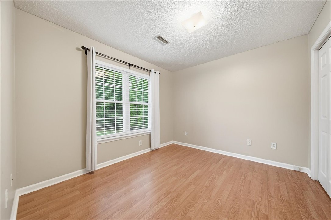 101 Grand Oak Circle Pendleton, SC 29670 - Photo 20 of 40 A well-lit bedroom with durable wood-look flooring and a window offering natural light.