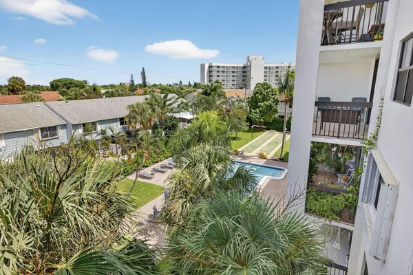a bedroom with a bed and a lamp on dresser