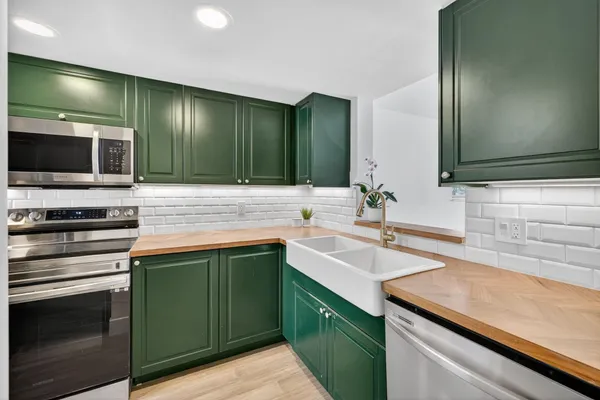 a kitchen with a sink stove and microwave