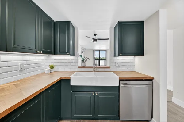 a kitchen with a sink and a mirror