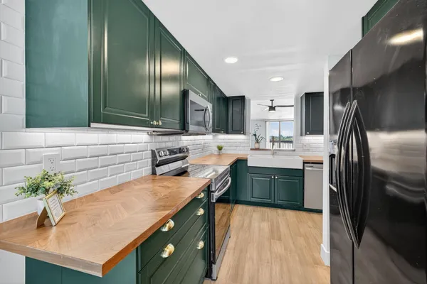 a kitchen with stainless steel appliances a sink stove and refrigerator