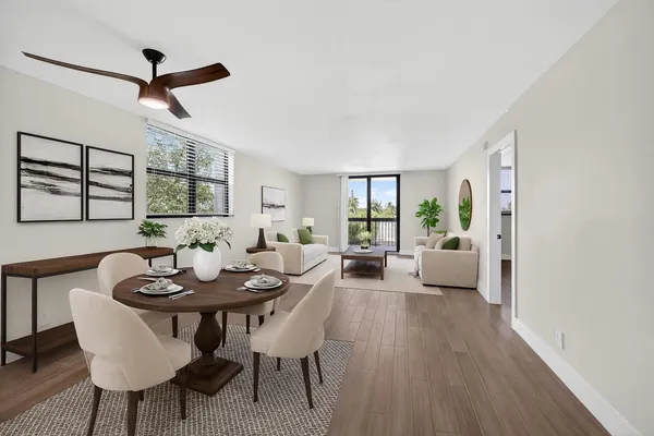 a living room with furniture a window and a table