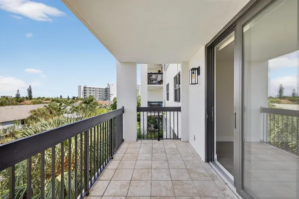 a view of a balcony with wooden floor