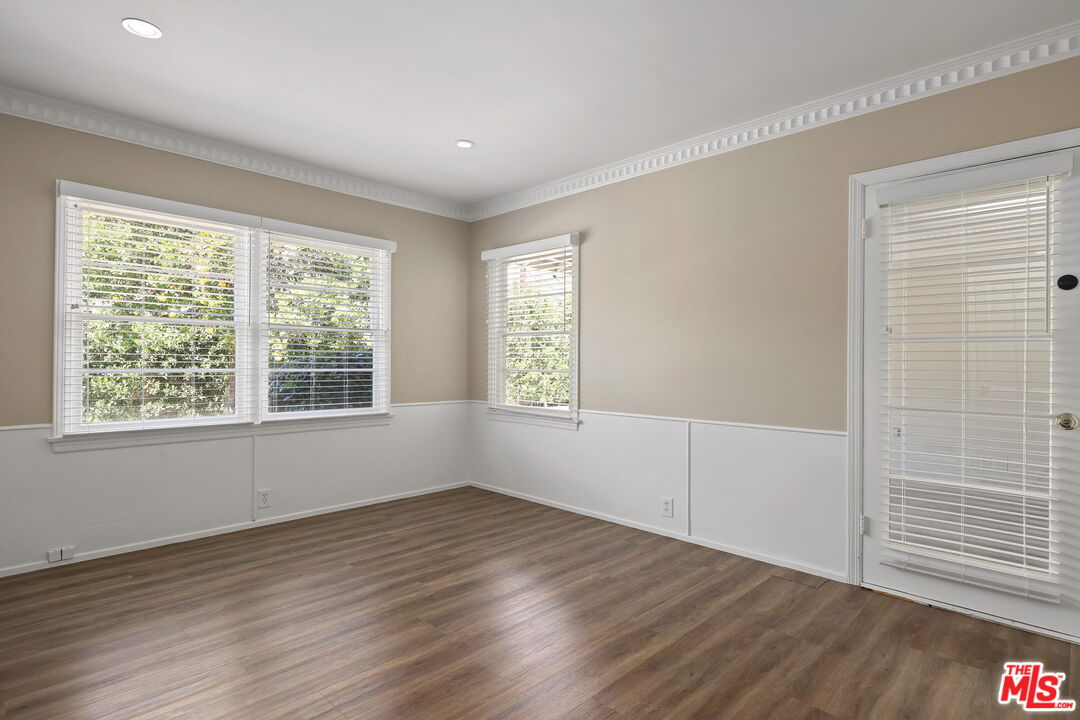 15415 Albright Street Pacific Palisades, CA 90272 - Photo 14 of 21 an empty room with wooden floor and windows