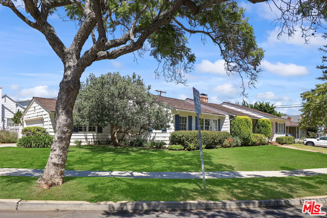 15415 Albright Street Pacific Palisades, CA 90272 - Photo 2 of 21 a view of a white house next to a yard with big trees