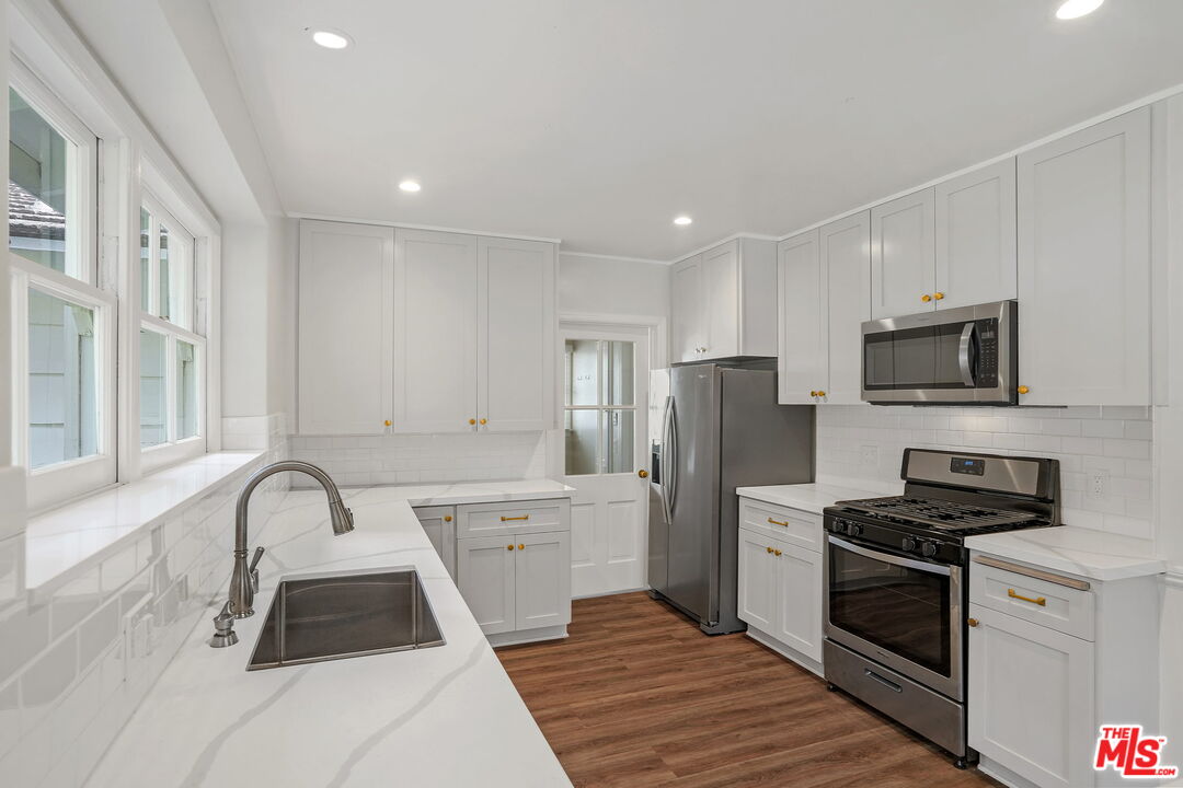 15415 Albright Street Pacific Palisades, CA 90272 - Photo 7 of 21 a kitchen with a sink appliances and cabinets