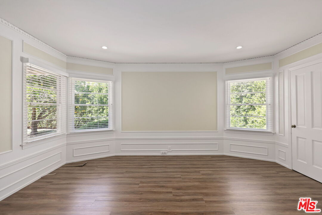 15415 Albright Street Pacific Palisades, CA 90272 - Photo 10 of 21 a view of an empty room with wooden floor and a window