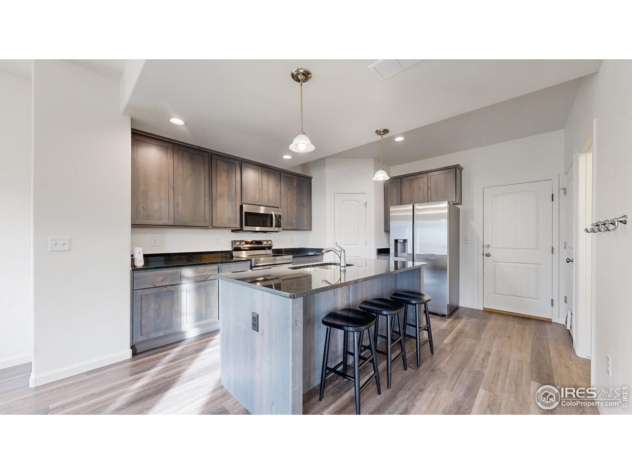 4355 24th Street Road, Unit 3202 Greeley, CO 80634 - Photo 6 of 33 Great Open Kitchen with 42" Upper Cabinets, Island, Pantry & Stainless Steele Appliances