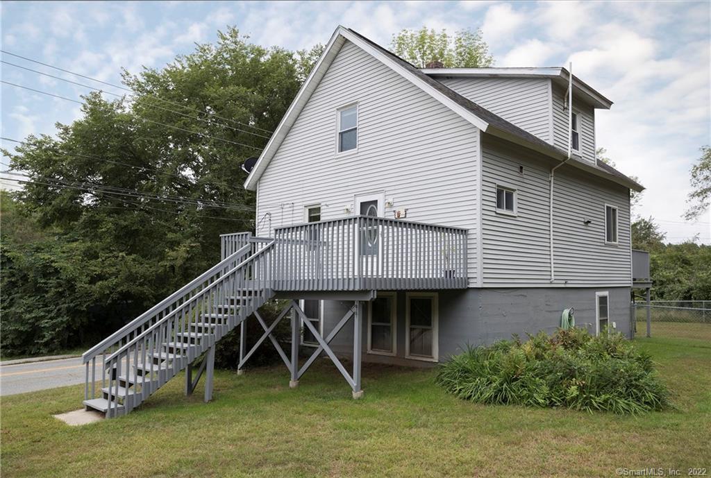 216 Canterbury Road Plainfield, CT 06374 - Photo 1 of 1 a roof deck with table and chairs under an umbrella