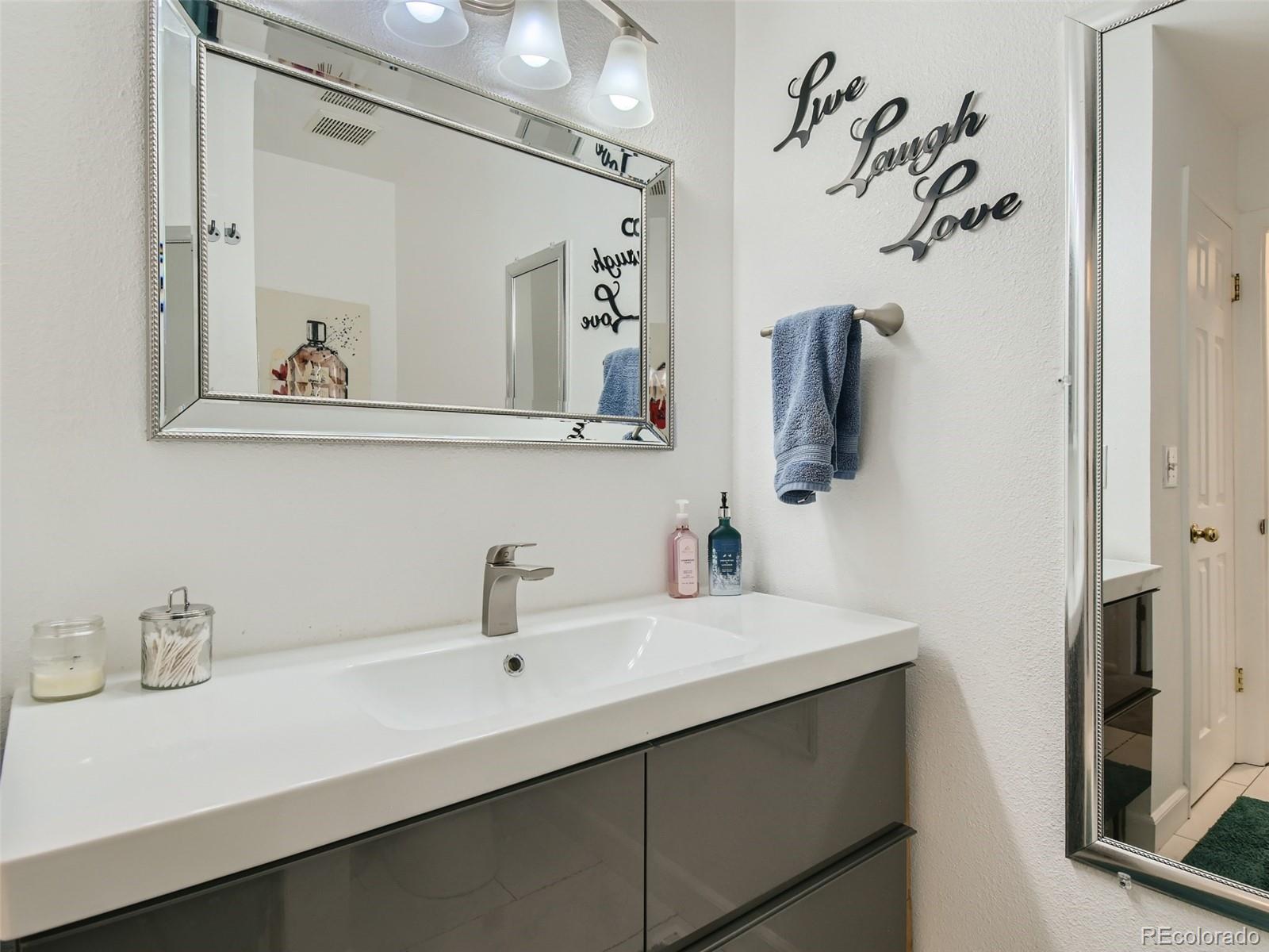 7994 Chase Circle, Unit 18 Arvada, CO 80003 - Photo 11 of 15 a bathroom with a sink and a mirror