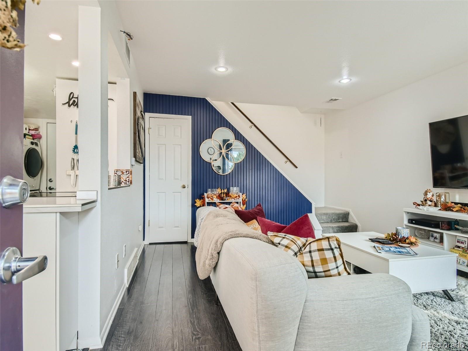 7994 Chase Circle, Unit 18 Arvada, CO 80003 - Photo 3 of 15 a bedroom with furniture and a wooden floor