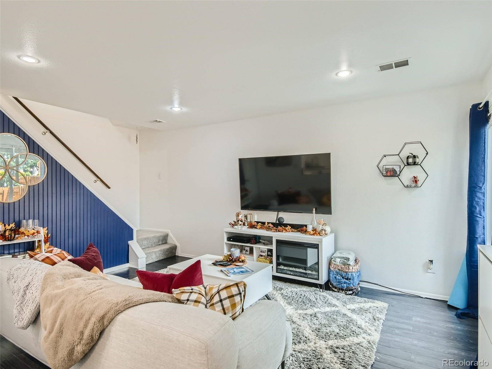 7994 Chase Circle, Unit 18 Arvada, CO 80003 - Photo 4 of 15 a living room with furniture and a flat screen tv