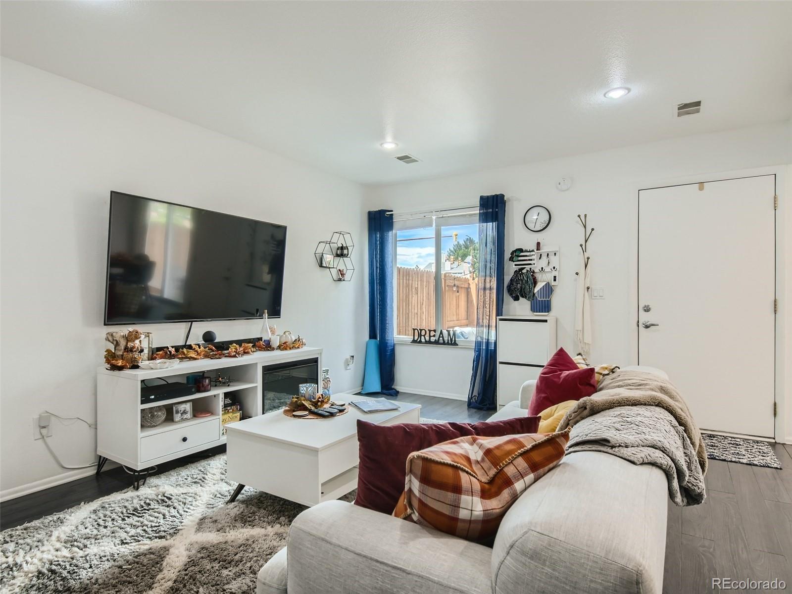 7994 Chase Circle, Unit 18 Arvada, CO 80003 - Photo 5 of 15 a living room with furniture and a flat screen tv