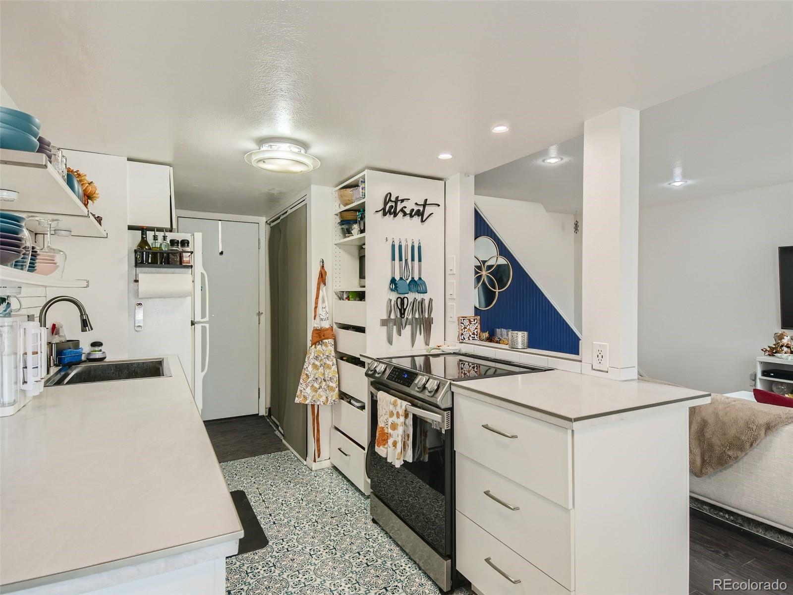 7994 Chase Circle, Unit 18 Arvada, CO 80003 - Photo 8 of 15 a kitchen with stainless steel appliances granite countertop a stove and a sink
