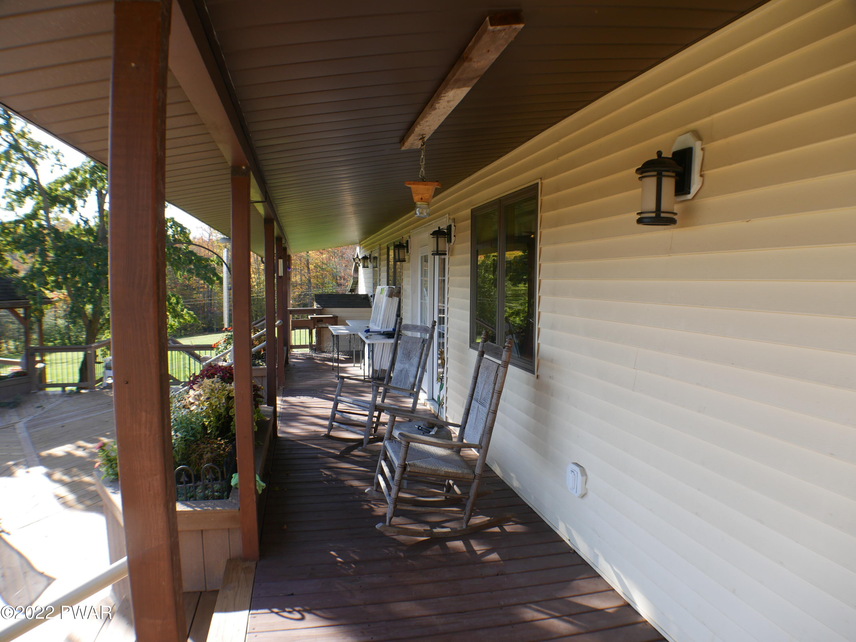 1259 Dougherty Road Meshoppen, PA 18630 - Photo 41 of 61 a view of a patio with table and chairs with wooden floor and floor to ceiling window