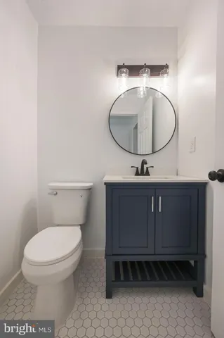 a bathroom with a toilet a sink and mirror