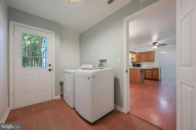 a utility room with cabinets washer and dryer