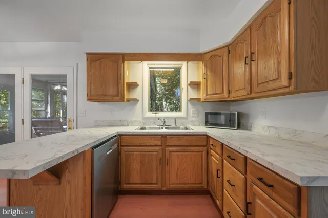 a kitchen with sink cabinets and window