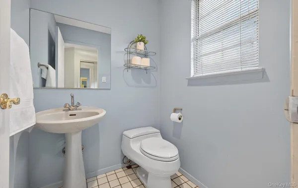 a bathroom with a sink a mirror and a toilet