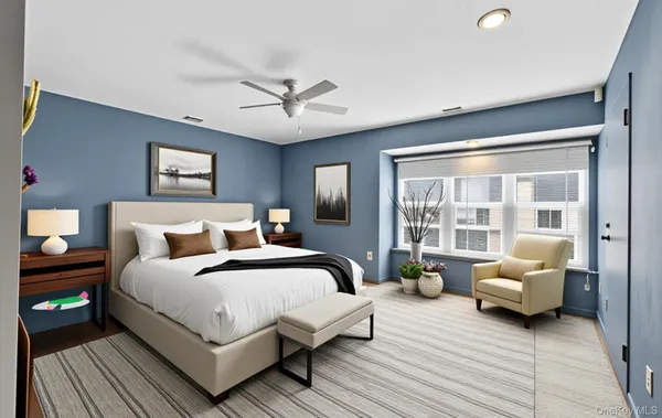 a spacious bedroom with a bed and a couch