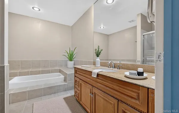 a bathroom with a granite countertop sink a toilet and bathtub